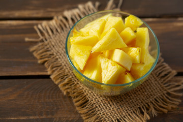 fresh pineapple pieces on wooden surface