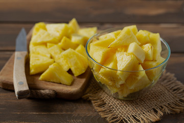 fresh pineapple pieces on wooden surface