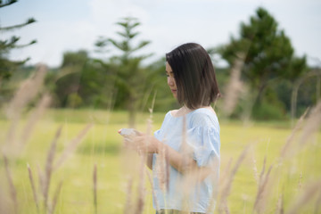 happy young cute Asian Japanese girl backpacker woman hipster guiding  female travelling women backpacking at beautiful sky mountains scenery  park garden views Kanchanaburi, Thailand. taking a photo