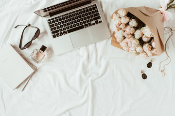 Fashion, beauty, lifestyle blogger home office workspace. Laptop, roses bouquet, women's...