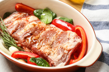 Raw spare ribs with garnish, closeup view