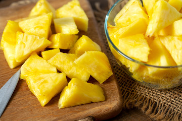 fresh pineapple pieces on wooden surface