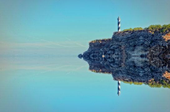 The lighthouse and its reflection in the sea of Portinatx, Ibiza