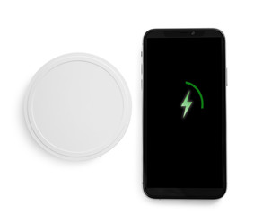 Wireless charger and smartphone isolated on white, top view