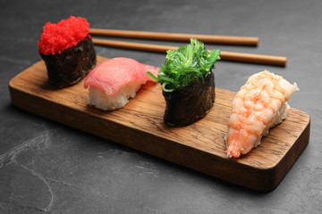 Set of delicious sushi on grey table
