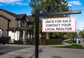 Units for sale contact your local realtor sing. In front of a house in a residential neighborhood.