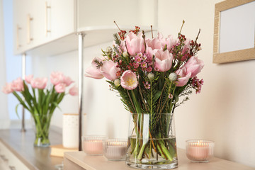 Beautiful bouquet with spring pink tulips on table indoors. Space for text