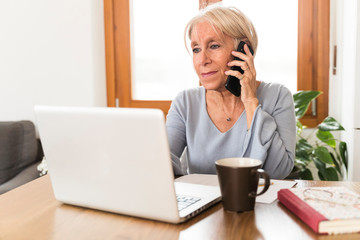 Adult retired woman working at home