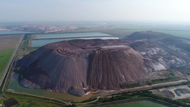 overview of the territory of the potash plant and slurry mountains of heaps, several enterprises located one near one, 4k