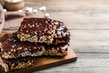 Delicious rice crispy treats on wooden table, closeup