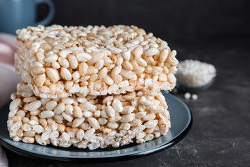 Delicious rice crispy treats on grey table, closeup