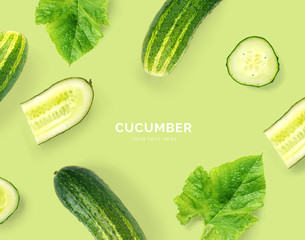 Creative layout made of cucumber. Flat lay. Food concept. Macro concept. green background.