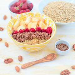 healthy breakfast oatmeal with fruits, raspberries, peach, flax seeds, nuts, good morning concept, healthy food, healthy breakfast