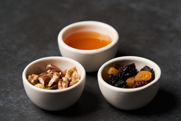 Healthy breakfast snacks for Oatmeal porridge. Dry raisins, honey and nuts