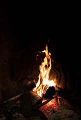 Fiery flames of a burning fire in a fireplace