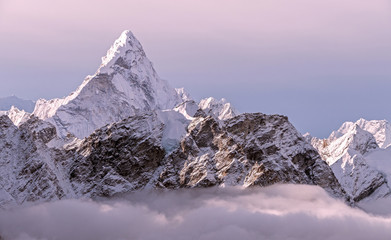 Greatness of nature concept: majestic Ama Dablam peak (6856 m) towering above the clouds in the morning light  Nepal, Himalayas mountains