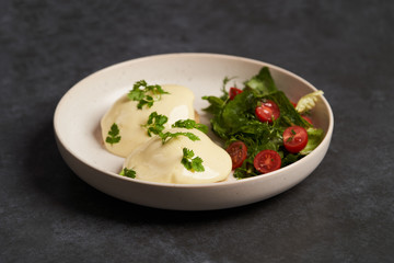 Eggs benedict with bacon meat and fish, close-up