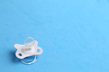 white pacifier in color background