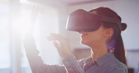 An young woman is using innovative technology vr glasses for play games and relax herself after hard working day. Shot in 8K. Concept of future, innovation, technology, gaming,lifestyle, entertainment - Powered by Adobe