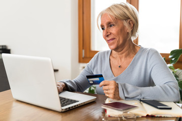 senior woman doing shopping online with the laptop