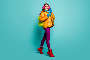 Full size photo of cheerful dreamy woman go walk winter lectures hold bag wear yellow pink purple red green jumper outfit isolated over teal color background