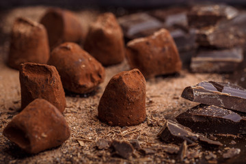 Homemade chocolate truffles on a dark background. Delicious gourmet candy. Selective focus