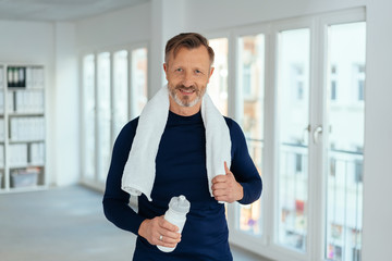 Fit healthy mature man after a workout at work