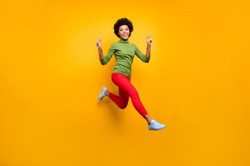 Fototapeta na wymiar Full length body size view of her she nice attractive lovely cheerful cheery wavy-haired girl jumping showing v-sign having fun isolated over bright vivid shine vibrant yellow color background