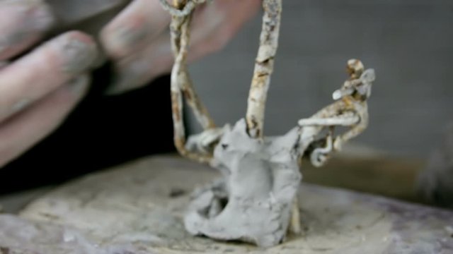 Hands makes a clay sculpture. The sculptor man makes a clay sculpture. Sculptor shapes the clay with hands close up