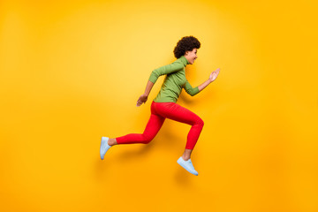 Fototapeta na wymiar Full length body size profile side view of nice attractive lovely cheerful cheery wavy-haired girl jumping running active life isolated over bright vivid shine vibrant yellow color background