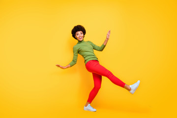 Fototapeta na wymiar Full length body size view of her she nice attractive teenage cheerful wavy-haired girl having fun free time pretending falling down isolated over bright vivid shine vibrant yellow color background