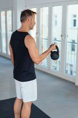 Man working out lifting kettlebell weight