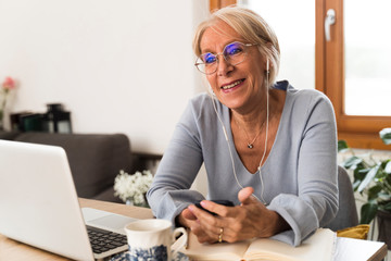 Smiling adult woman with a smartphone