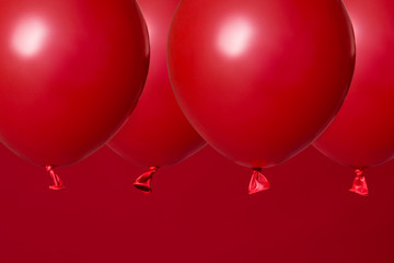 red helium balloons on red background