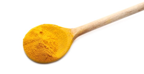 Turmeric powder pile with wooden spoon isolated on white background