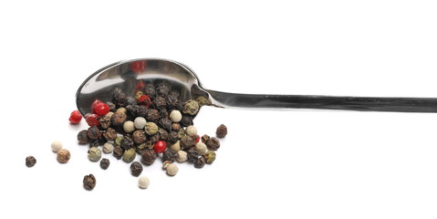 Mixed colorful peppercorns with metal spoon isolated on white background