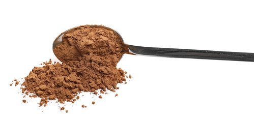 Cocoa powder pile with metal spoon isolated on white background