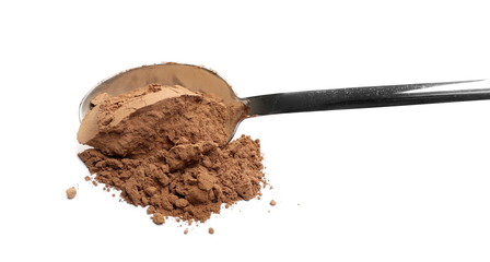 Cocoa powder pile with metal spoon isolated on white background