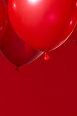 red helium balloons on red background