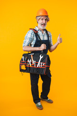 Man builder in helmet showing thumbs up.