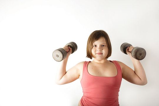 Chubby fat preteen girl with large dumbbells