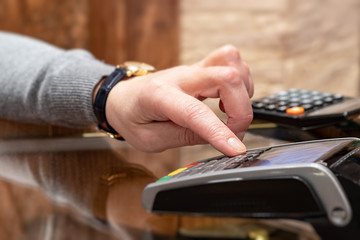 Payment by card, in the payment terminal. Electronic money. Mobile banking. Shopping complex.