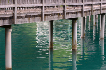 wooden bridge over alpine lake in south tyrol. Italy.