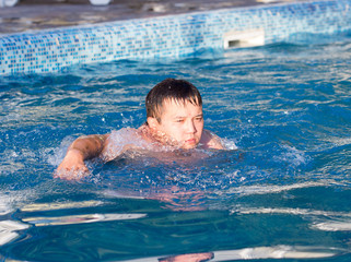 young man bathes in pool