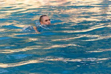 young man bathes in pool