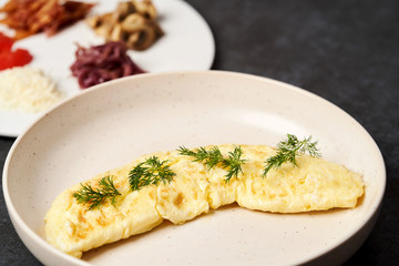 Traditional breakfast omelette with bacon, tomatoes, mushrooms, onion