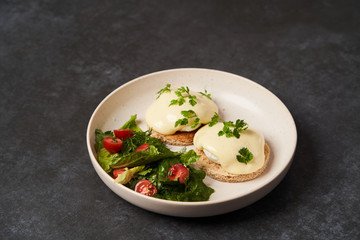 Eggs benedict with bacon meat and fish, close-up