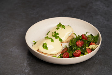 Eggs benedict with bacon meat and fish, close-up