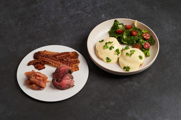 Eggs benedict with bacon meat and fish, close-up
