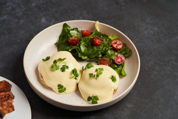 Eggs benedict with bacon meat and fish, close-up
